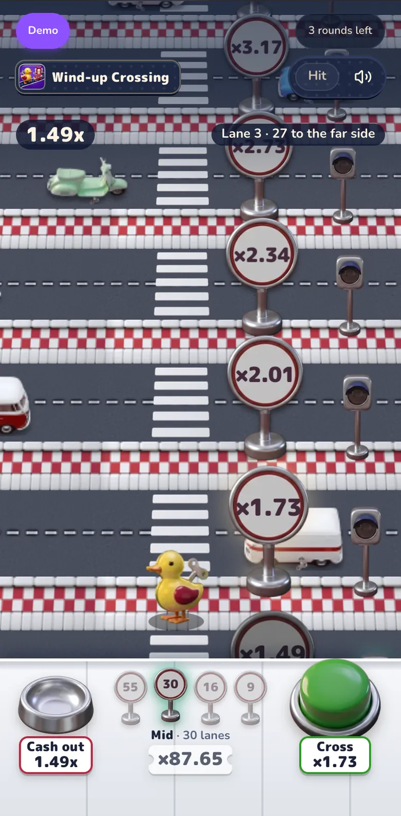 Wind-up Crossing mid-round on the Mid road: the wind-up duckling on the pavement after crossing three lanes, toy cars on the zebra roads, road signs with each lane's multiplier, and the console with the cash-out cup, the four road signs and the green Cross button